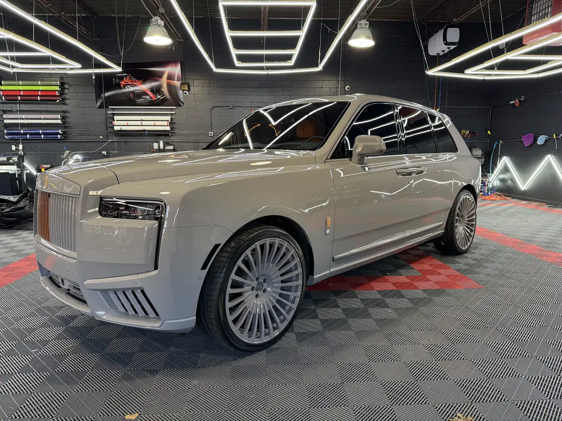 Grey Rolls-Royce Cullinan with full-body paint protection film inside the Detali studio.